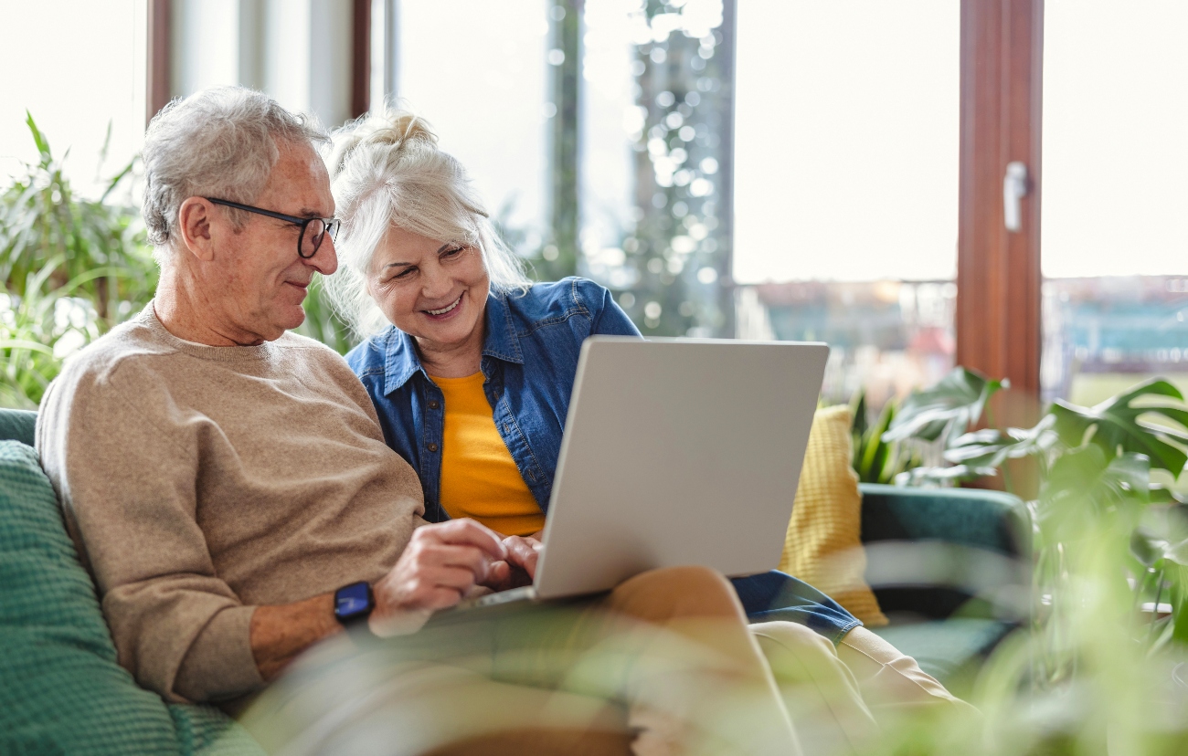 Elderly couple looking at a laptop