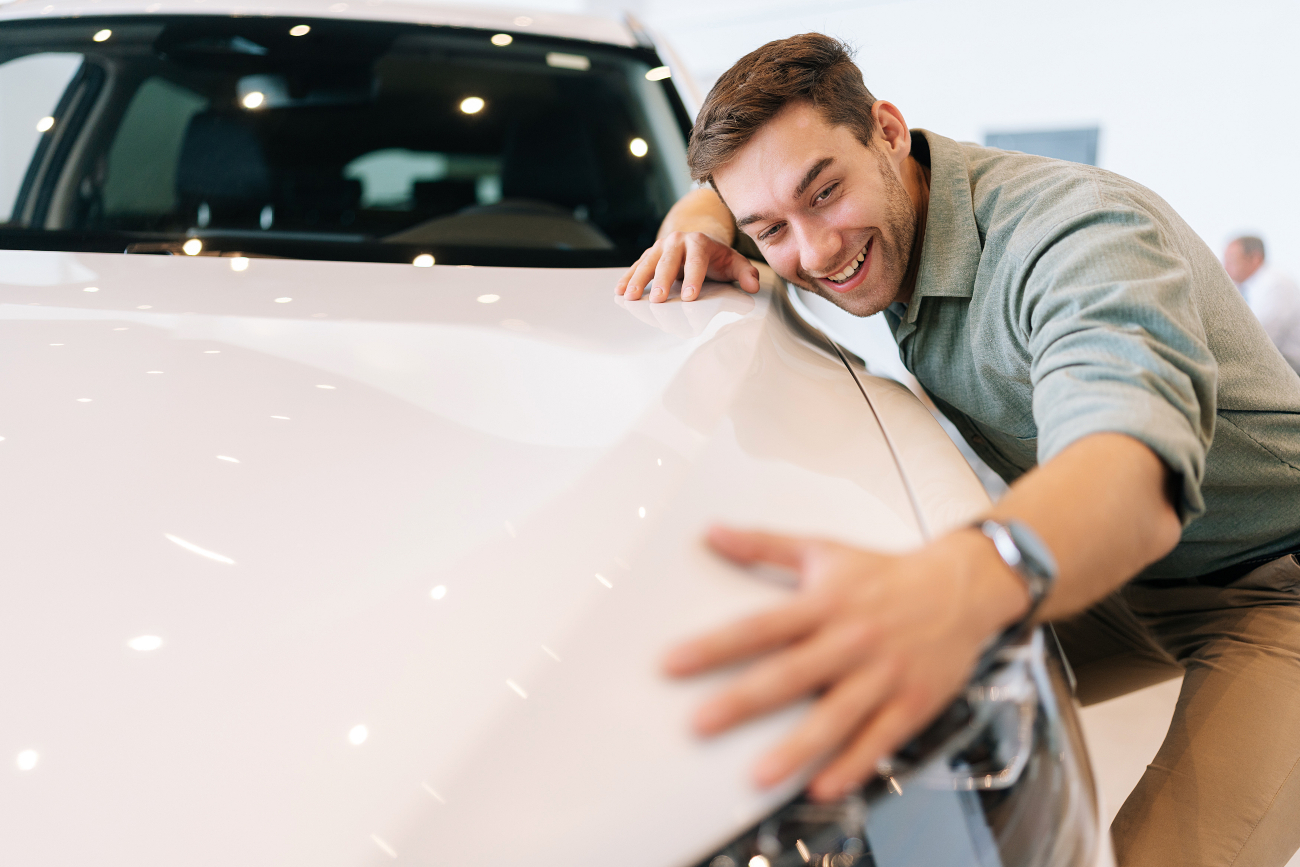 man hugging a car