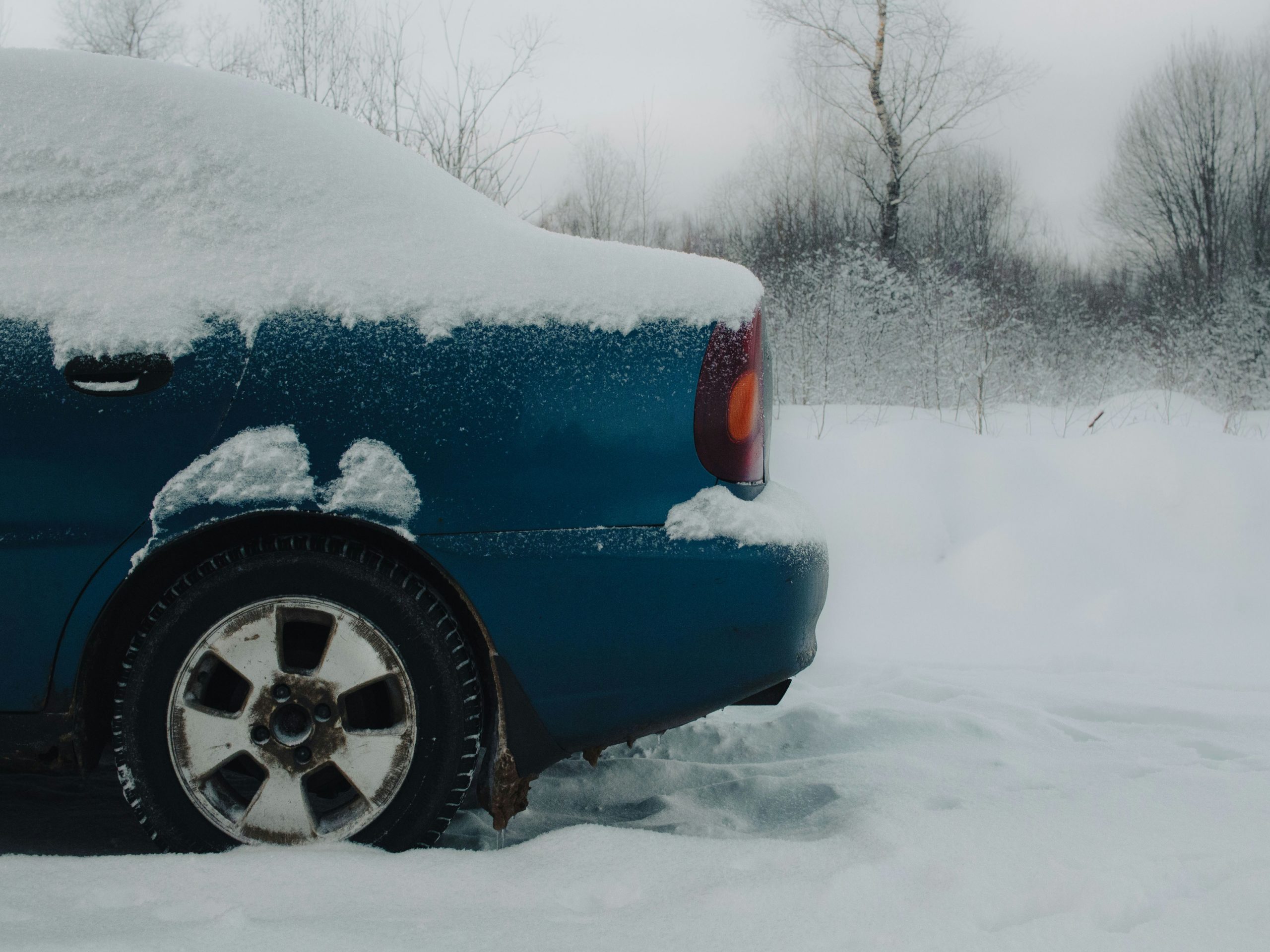 blue car covered in snow