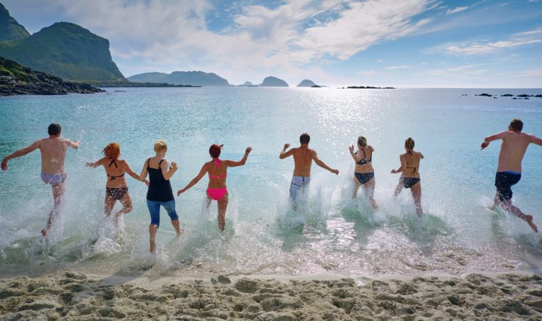 a family running into the sea